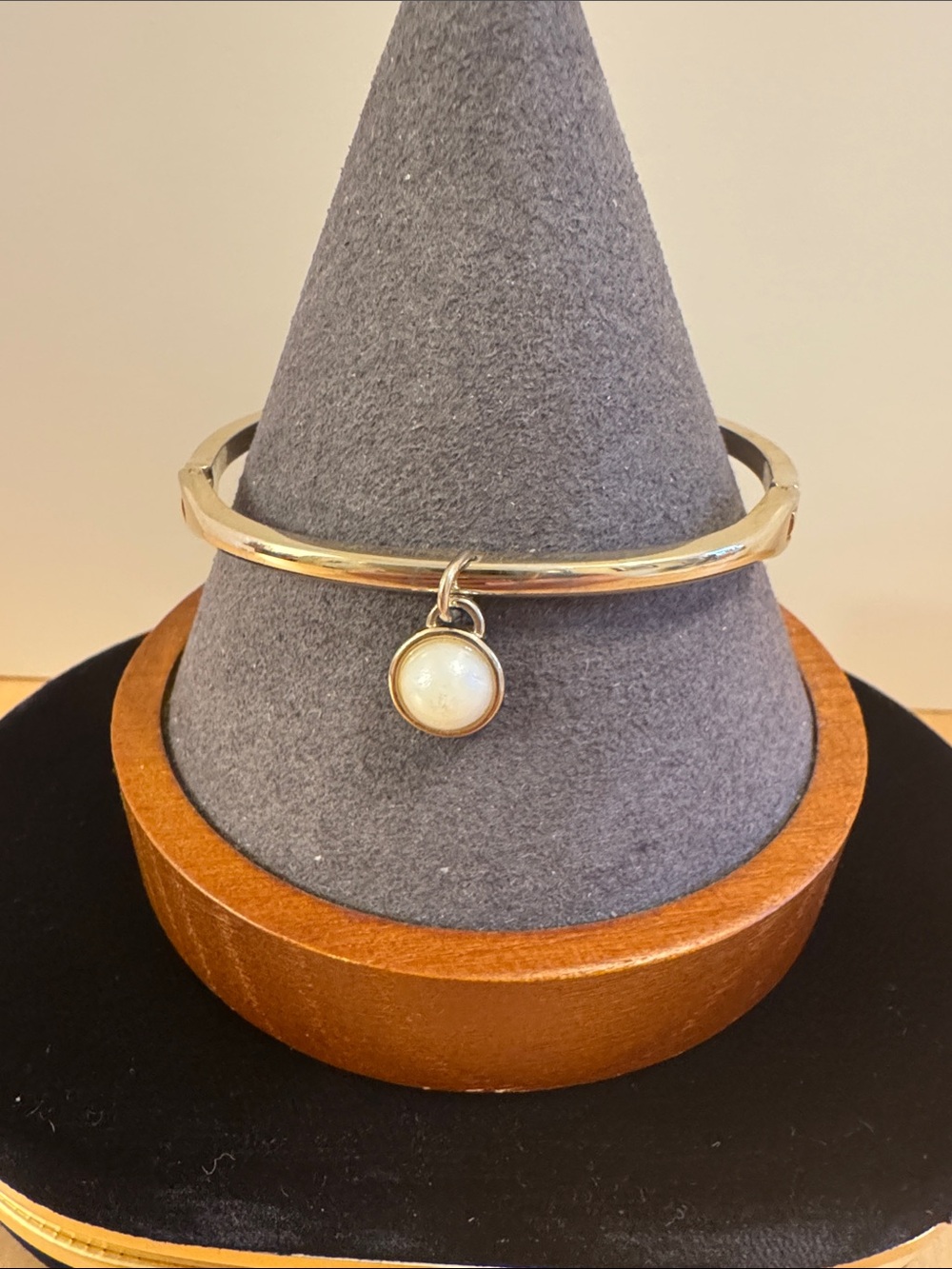 Silver tone bangle with faux pearl charm
